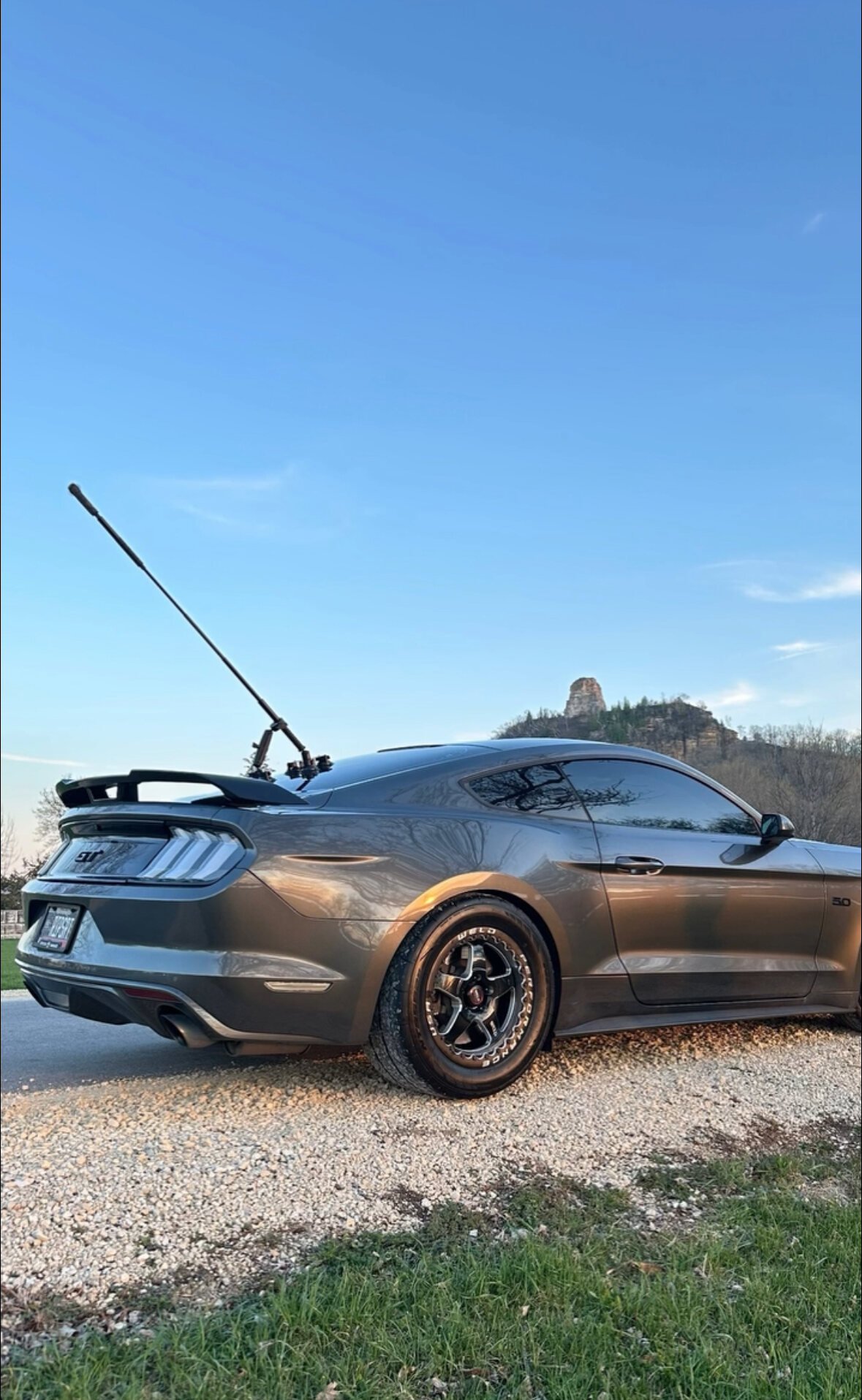 Mustang GT at golden hour beneath Sugarloaf bluff after a Mecha Auto Spa detail